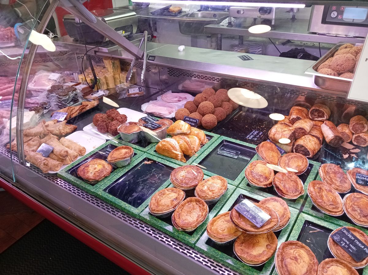 The pie counter at Easter Compton Farm Shop, rows of homemade pies behind the glass