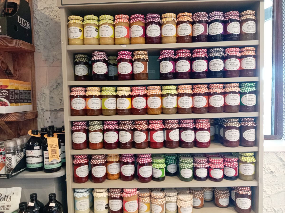 Shelves of preserves in fabric-topped jars at Easter Compton Farm Shop